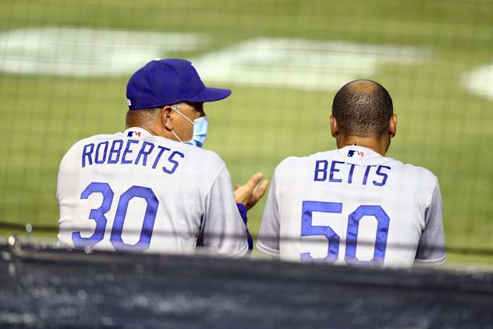 Jul 30, 2020; Phoenix, Arizona, USA; Los Angeles Dodgers manager Dave Roberts (left) with outfielder Mookie Betts against the Arizona Diamondbacks during the home opener at Chase Field. Mandatory Credit: Mark J. Rebilas-USA TODAY Sports